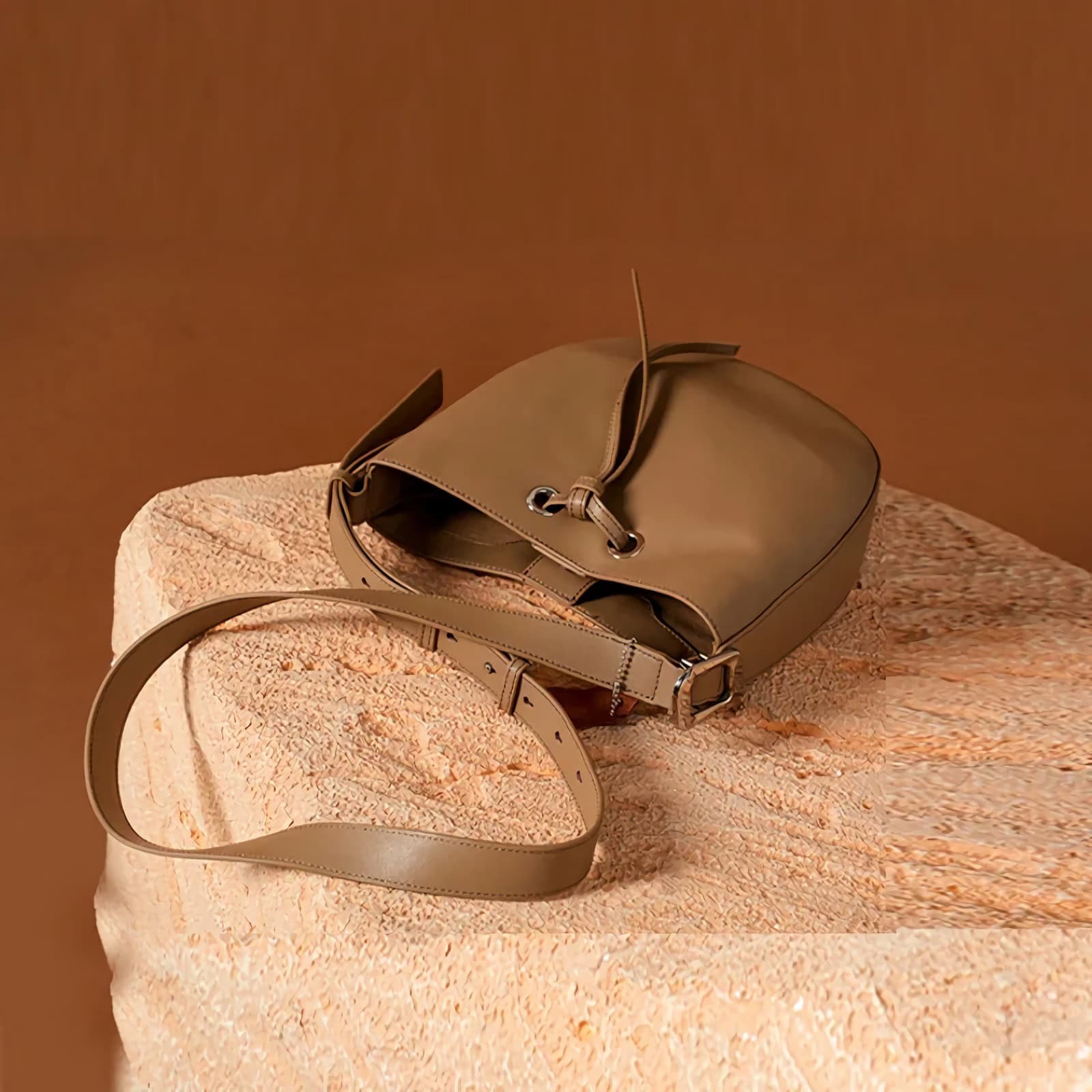 Elegant beige leather handbag with adjustable strap, trendy design, perfect for fashion-forward women seeking premium accessories.