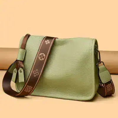 Elegant green leather handbag with adjustable strap, perfect for fashion-forward accessories and everyday use.