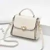 Luxury white leather handbag with gold hardware, chain details, and adjustable strap for women. Perfect for stylish outings and everyday use.