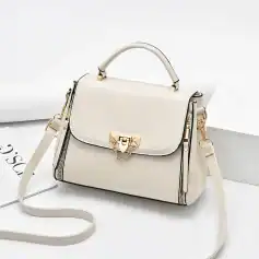 Luxury white leather handbag with gold hardware, chain details, and adjustable strap for women. Perfect for stylish outings and everyday use.