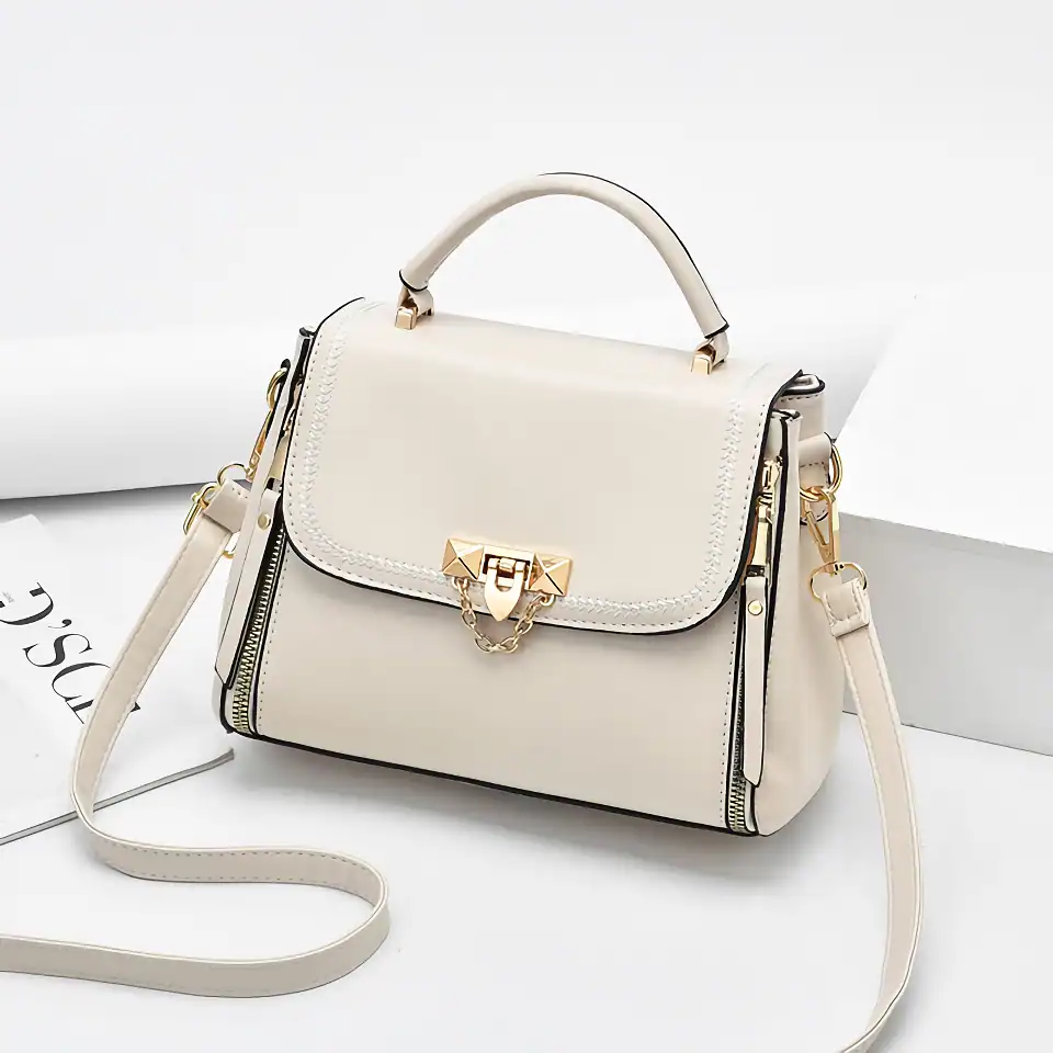 Luxury white leather handbag with gold hardware, chain details, and adjustable strap for women. Perfect for stylish outings and everyday use.