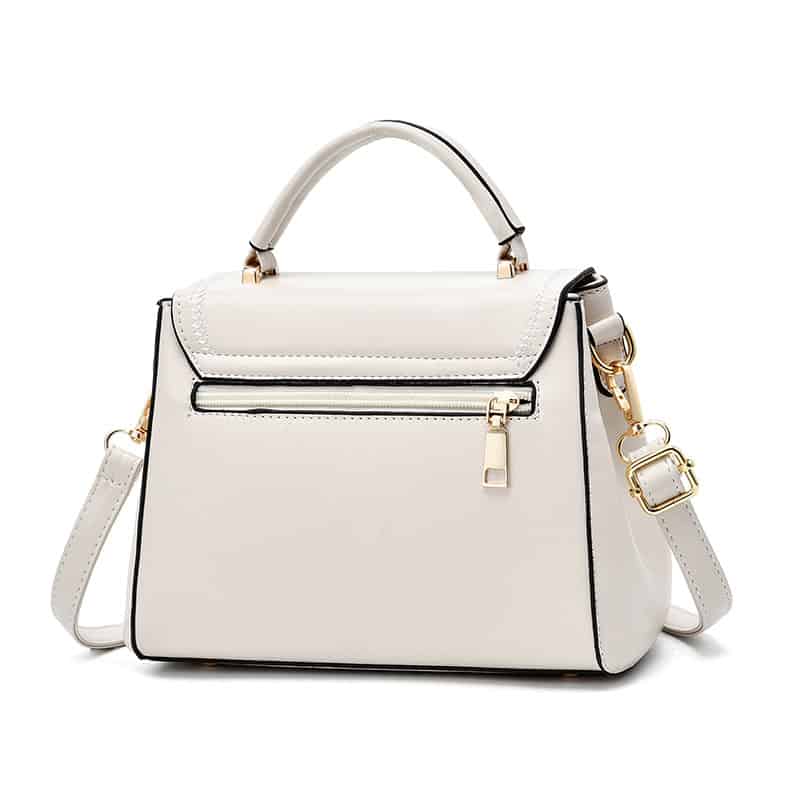 Stylish white handbag with gold accents, zip closure, and versatile strap, perfect for fashion-forward occasions and shopping.