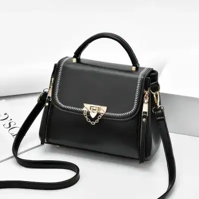 Elegant black fashion handbag featuring gold hardware and chain detail, perfect for stylish accessories and daily use.