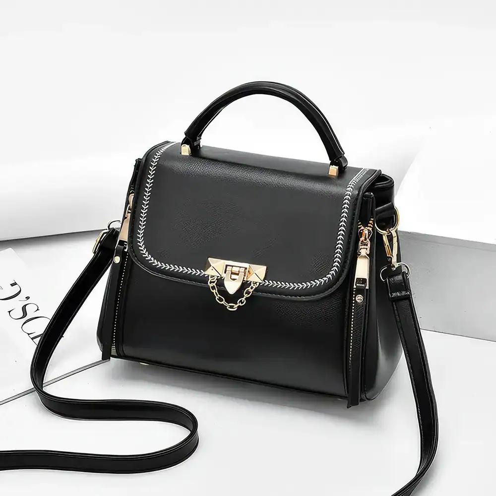 Elegant black fashion handbag featuring gold hardware and chain detail, perfect for stylish accessories and daily use.