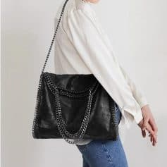 Black designer chain shoulder bag with silver-tone hardware, versatile and stylish. Perfect for fashion-conscious women seeking luxury accessories.
