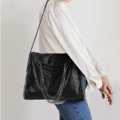 Black designer chain shoulder bag with silver-tone hardware, versatile and stylish. Perfect for fashion-conscious women seeking luxury accessories.