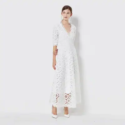 Stylish white lace maxi dress with intricate cutout details for summer fashion. Perfect for special occasions, weddings, or stylish outings. Comfortable, chic, and trendsetting.