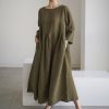 Fashionable olive green maxi dress with a relaxed fit, long sleeves, and side pockets, perfect for casual and stylish occasions.
