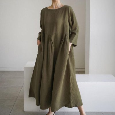 Fashionable olive green maxi dress with a relaxed fit, long sleeves, and side pockets, perfect for casual and stylish occasions.