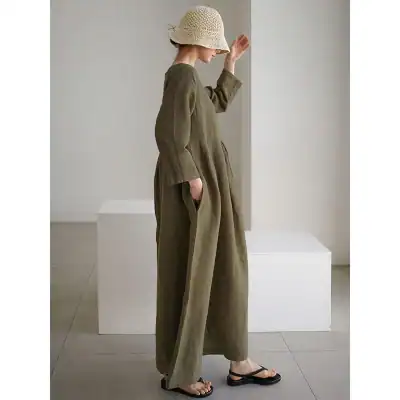 Beautiful olive-green linen jumpsuit with a loose fit, wide legs, and pocket detailing, perfect for stylish comfort and casual wear.