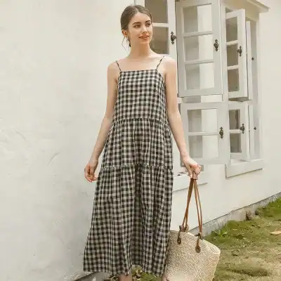 Elegant black and white gingham maxi dress with adjustable spaghetti straps, perfect for summer, casual outings, or beachwear. Comfortable and stylish for everyday wear.