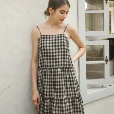 Elegant black and white checkered dress with spaghetti straps, perfect for casual wear or summer outings. Comfortable and trendy fashion from Monalisa Medical Store.