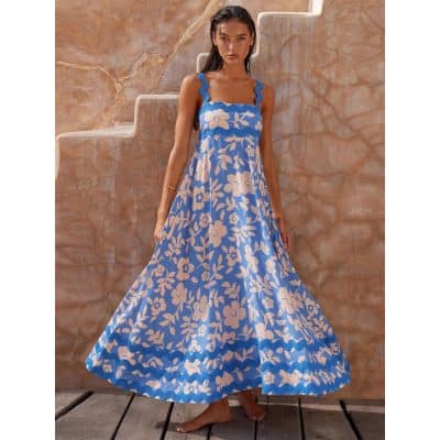 Stunning blue floral maxi dress featuring ruffled shoulder straps, flowy silhouette, perfect for summer or resort wear, made from lightweight, breathable fabric.