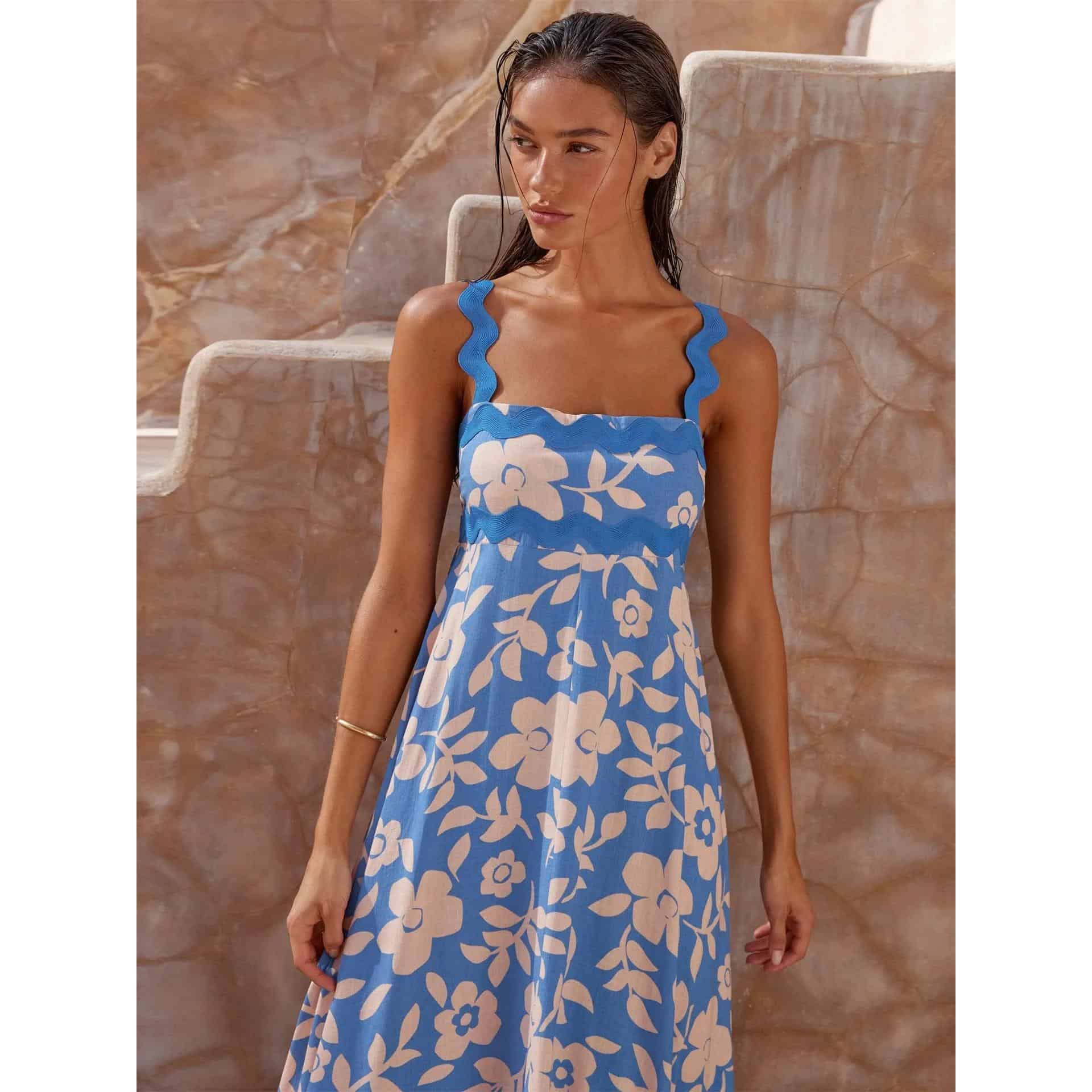 Stylish blue floral summer dress with ruffled straps, perfect for fashionable occasions and outdoor events.