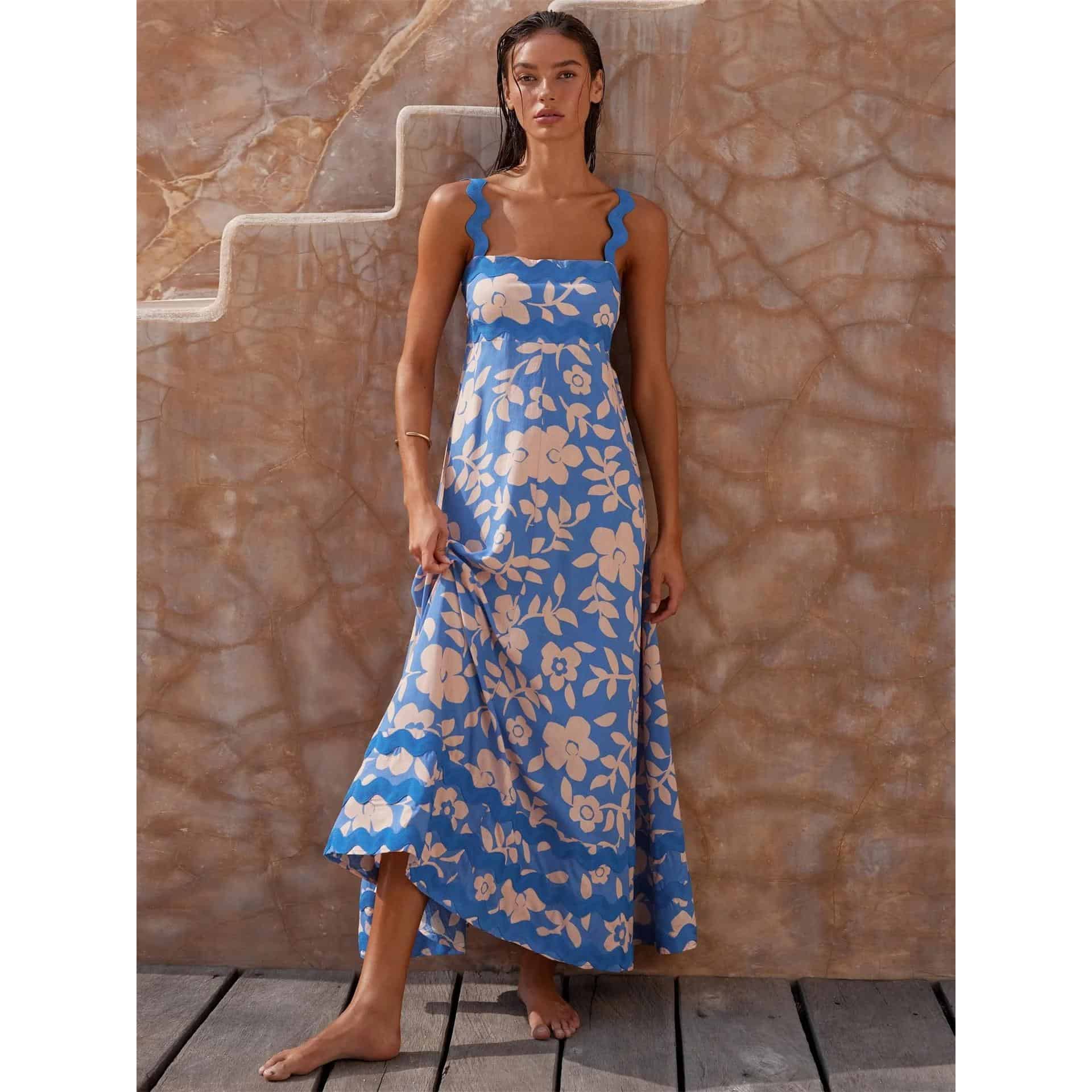 Woman wearing blue and beige floral maxi dress, relaxed summer style for beach or casual outings, stylish and comfortable, perfect for warm weather.
