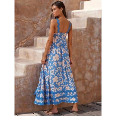 Stylish blue and beige floral maxi dress perfect for summer and beach outings. Features a fitted waist, flowy skirt, and sleeveless design for a comfortable yet fashionable look.