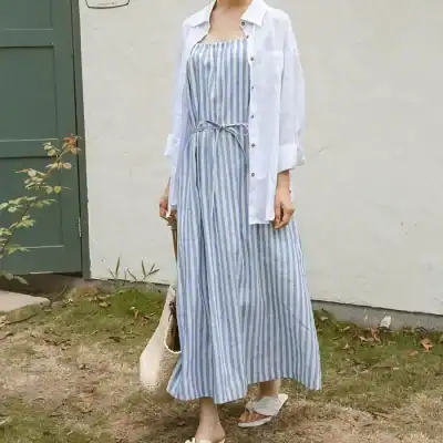 Elegant striped maxi dress paired with a white shirt, perfect for summer outings and casual wear, offering style and comfort for women.