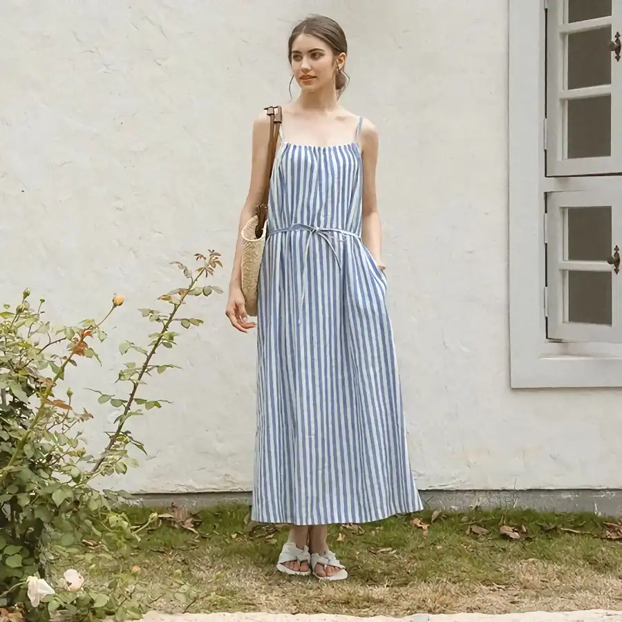 Elegant blue and white striped maxi dress perfect for summer, casual outings, or beachwear. Features adjustable straps and a comfortable fit for all-day wear.