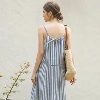 Comfortable blue and white striped summer dress with spaghetti straps and a back bow tie, perfect for casual and beachwear.