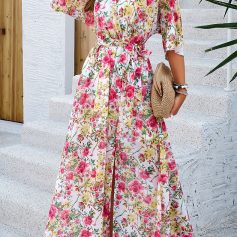 Elegant floral maxi dress perfect for summer and beach outings, featuring vibrant pink, yellow, and green patterns, with a flattering waist tie and flowy design.