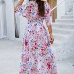 Elegant floral maxi dress with vibrant pink, purple, and white blossoms, perfect for sunny days and outdoor events. Features a flowy design, comfortable fit, and stylish look.