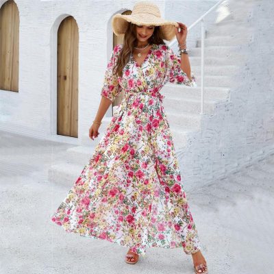 Stylish floral maxi dress with vibrant pink and green patterns, perfect for summer and vacation wear. Made from lightweight, breathable fabric, offering comfort and style for all occasions.