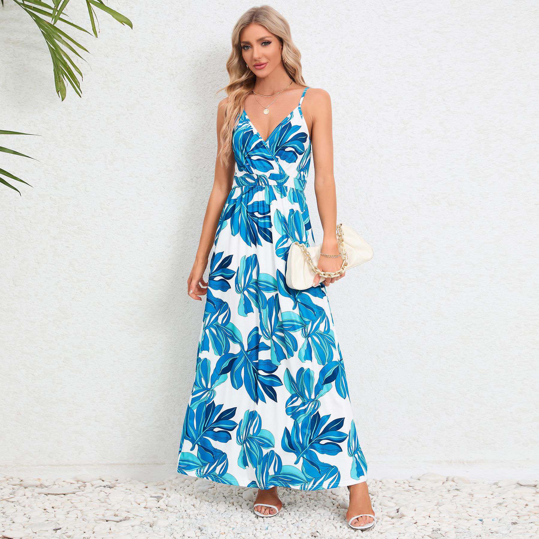 Stylish white and blue tropical print maxi dress with spaghetti straps for women.