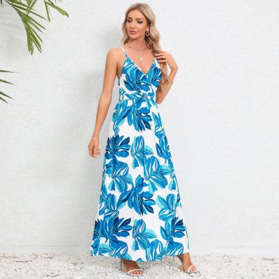 Fashionable blue and white tropical print maxi dress perfect for summer, beach, or vacation wear. Features spaghetti straps, V-neckline, and comfortable flowy design.