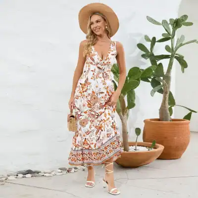 Elegant boho floral maxi dress for women, perfect for summer and casual occasions, featuring vibrant orange and white patterns.