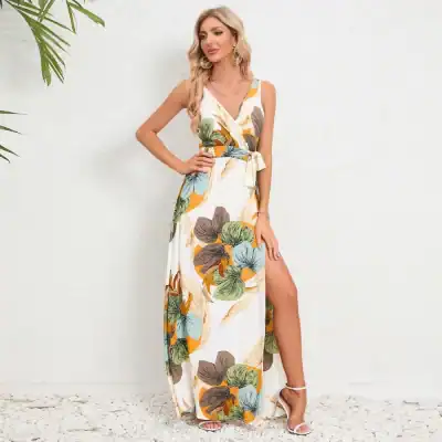 Elegant floral maxi dress with side slit, perfect for summer and special occasions. Features a vibrant leaf print, sleeveless design, and tie waist for a flattering fit. Shop Monalisa Medical for stylish fashion.