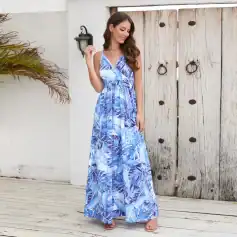 Elegant blue tropical print maxi dress perfect for summer and resort wear, featuring a flowy silhouette and adjustable straps. Ideal for women seeking stylish and comfortable beach or vacation fashion.