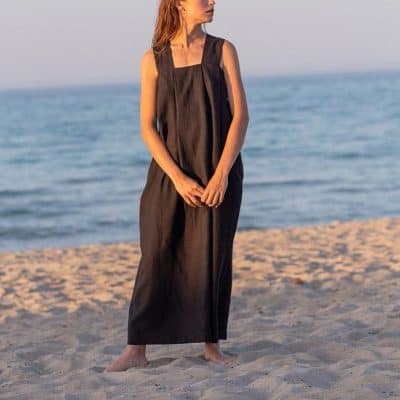 Stylish black linen dress for beach or resort wear, perfect for summer vacation. Comfortable and elegant, ideal for women seeking chic resort-style clothing.