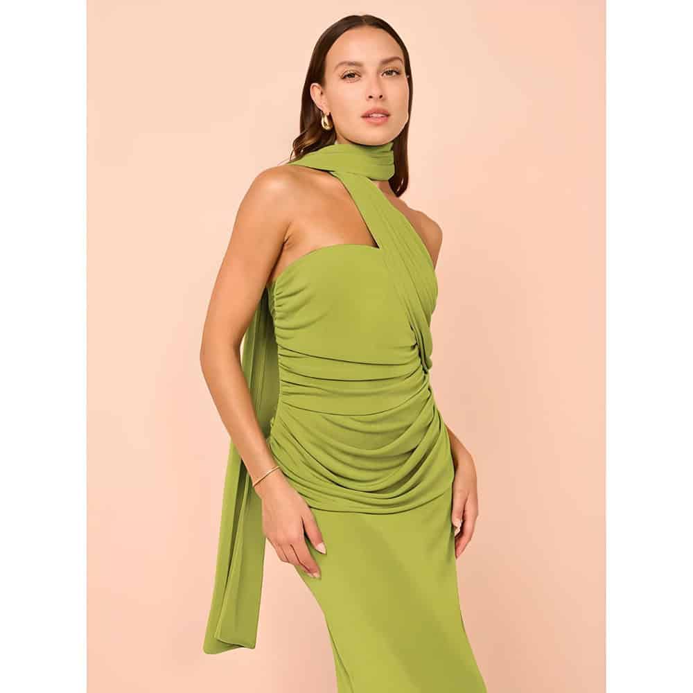 A stylish woman wearing a vibrant green, draped evening gown with unique design, perfect for special occasions. High-quality fashion from Monalisa Store, ideal for modern women's wardrobe.