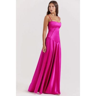 Stylish pink satin evening gown with spaghetti straps, fitted bodice, and flowing skirt, ideal for formal events and celebrations. Crafted from luxurious satin for a sophisticated look.