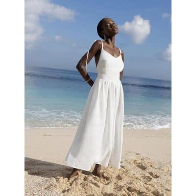 A stylish white maxi dress perfect for beach outings, sun protection, and summer fashion. Lightweight, flowing, and comfortable, ideal for a trendy seaside look.