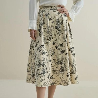 A stylish, high-waisted skirt featuring a black and cream botanical pattern, perfect for sophisticated looks. Made from quality fabric, it offers a comfortable fit and versatile style.