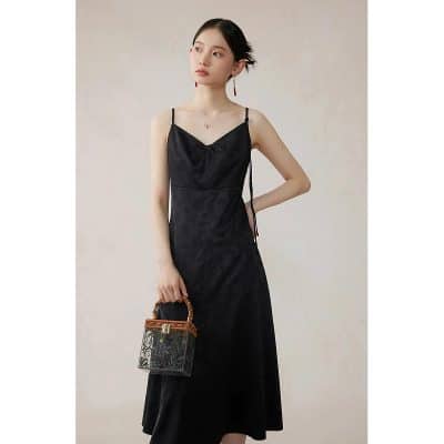 High-quality black slip dress with delicate details, perfect for fashionable women seeking elegant and trendy outfits. Crafted with premium materials for comfort and style.