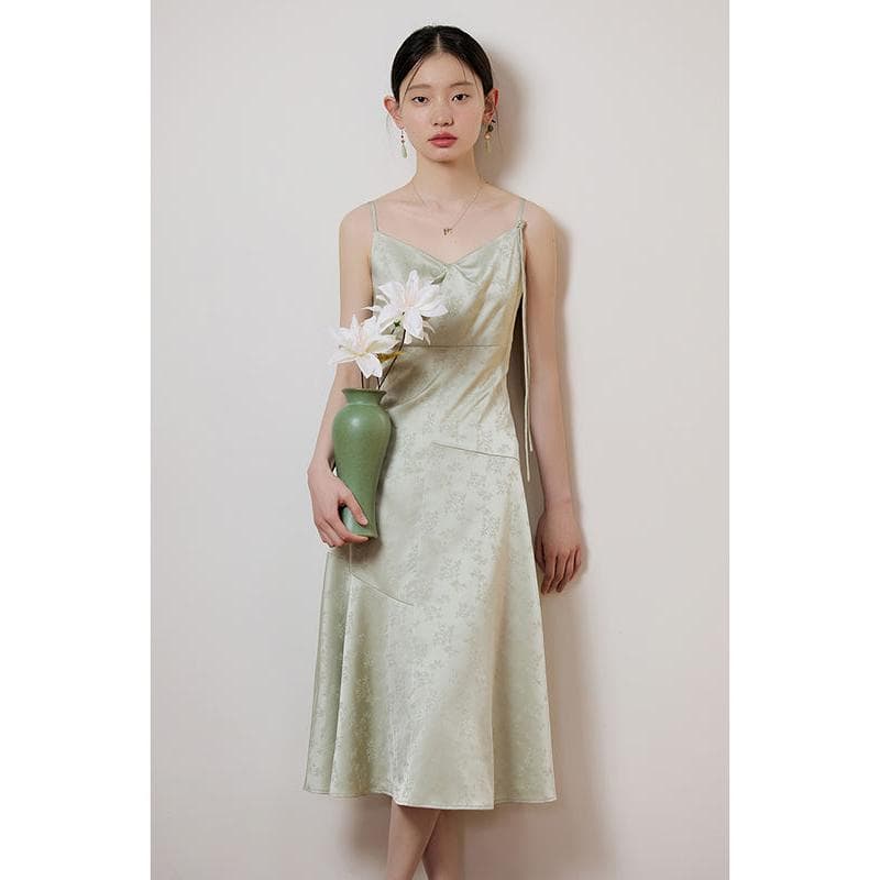 Young woman wearing a luxurious silk dress by Monalisa Store standing with a flower vase. Perfect for fashion, style, and special occasions.