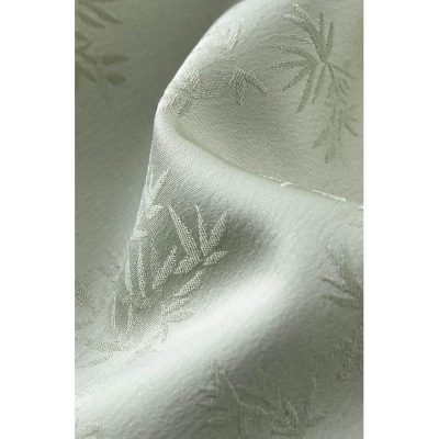 Luxurious ivory curtain featuring a subtle bamboo print, ideal for modern and traditional interiors, provides light control and style.