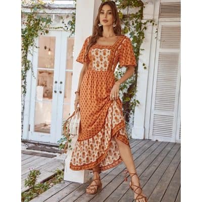 Stylish bohemian maxi dress with intricate orange and cream embroidery, perfect for summer and casual outings. Made with lightweight, breathable fabric, offering a comfortable fit and chic look.