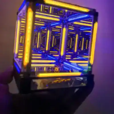 A futuristic illuminated neon optical cube with vibrant blue and yellow lights, showcasing advanced optical technology and modern design.