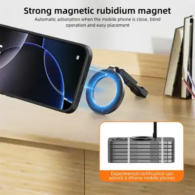 Phone attached to a glowing blue circular magnetic charger on a wooden desk, with a stand and books in the background.