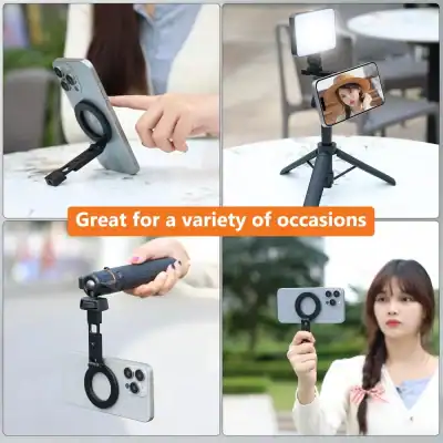 Phone with a circular finger grip attached on a small stand on a table (desk setup).